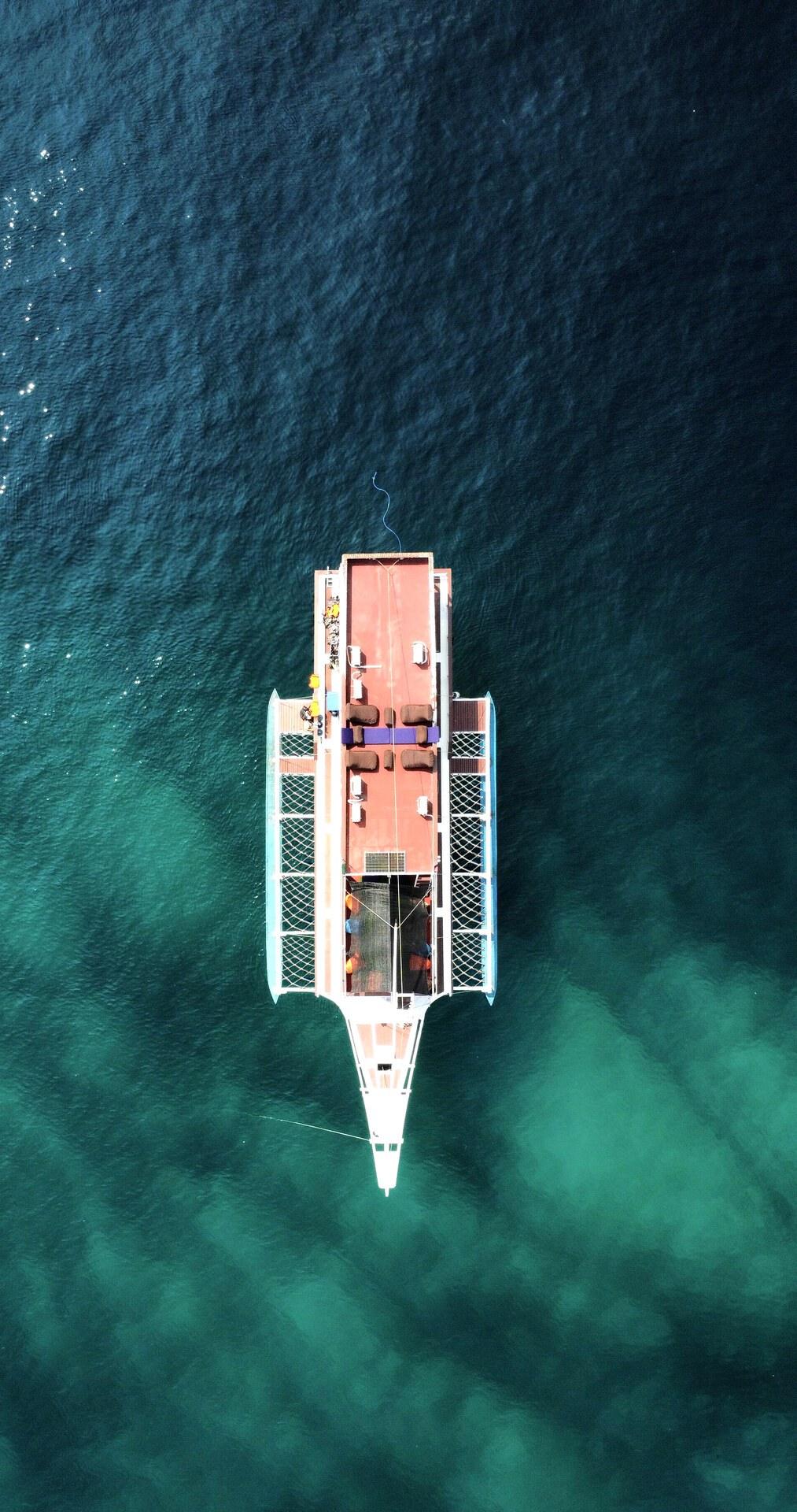 Top-down aerial of King Cirox 2 with netted platforms either side of the bow