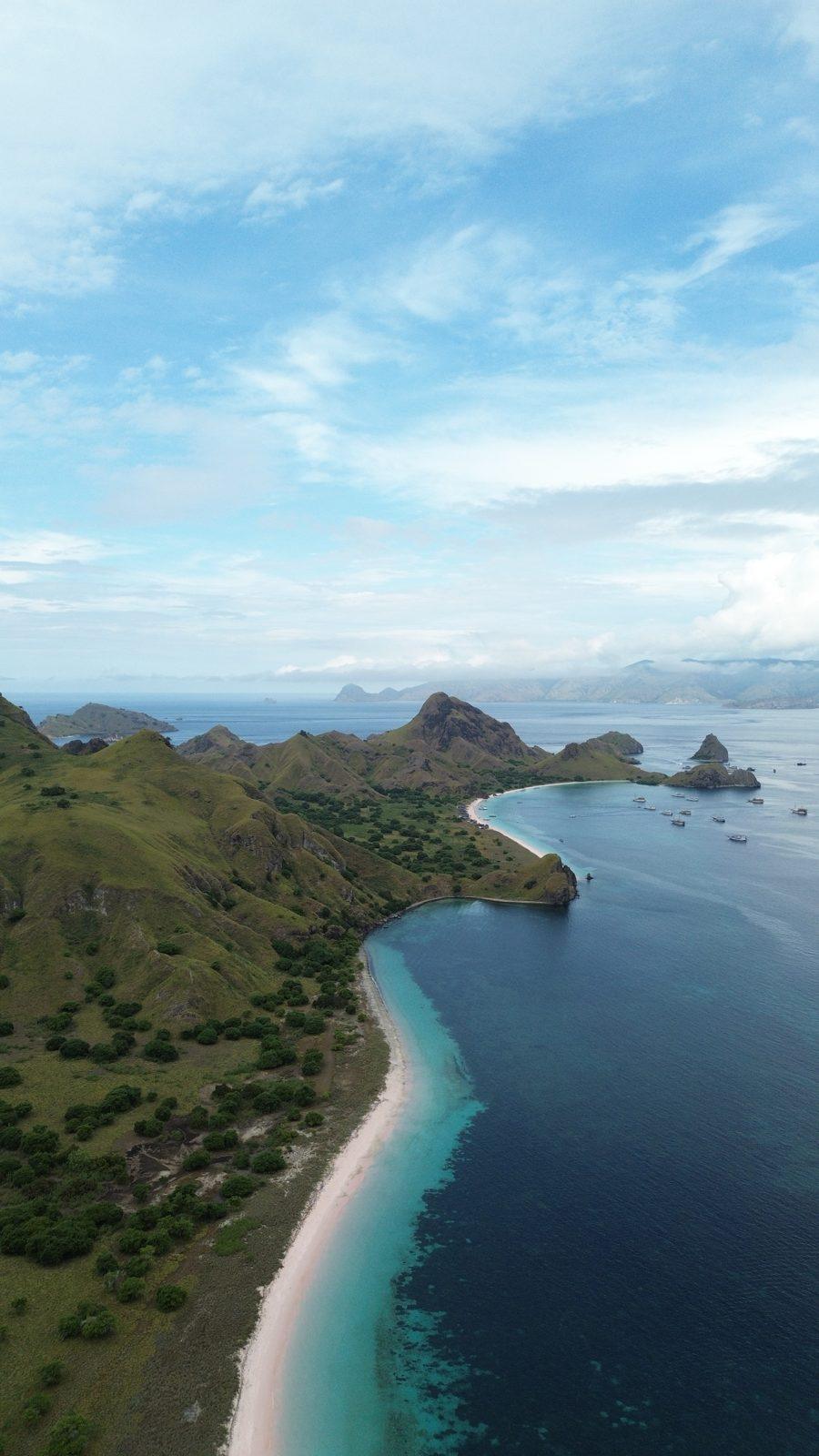 Padar – Aerial green headland, curved white beach (Real photo from a Komodo Explorer trip)