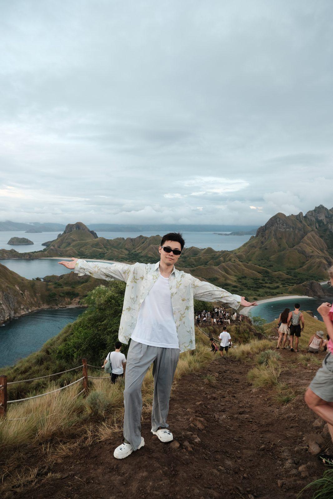 Padar – Man arms outstretched on Padar ridge (Real photo from a Komodo Explorer trip)